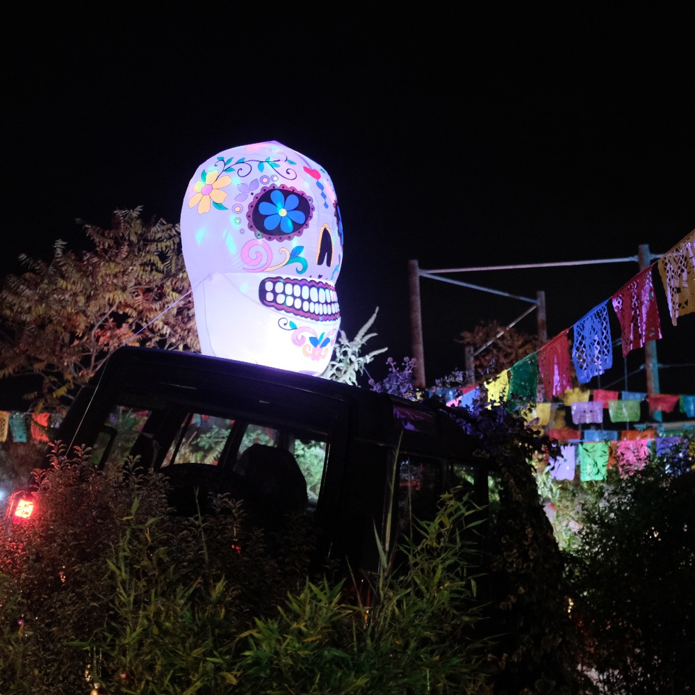 Neon Heights high ropes aerial adventure course glowing with neon lights, featuring zip lines, wobbly bridges, swingy steps, and a thrilling 70-metre zip wire descent under the night sky.