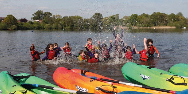 Children splashing in the lake at Aztec Adventure Upton Warren