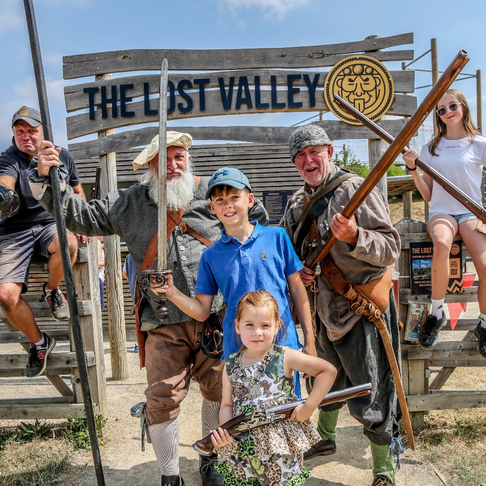 Aztec Adventure's Mark Spence and reenactors mark the launch of Victory at The Lost Valley at The Lost Valley entrance sign