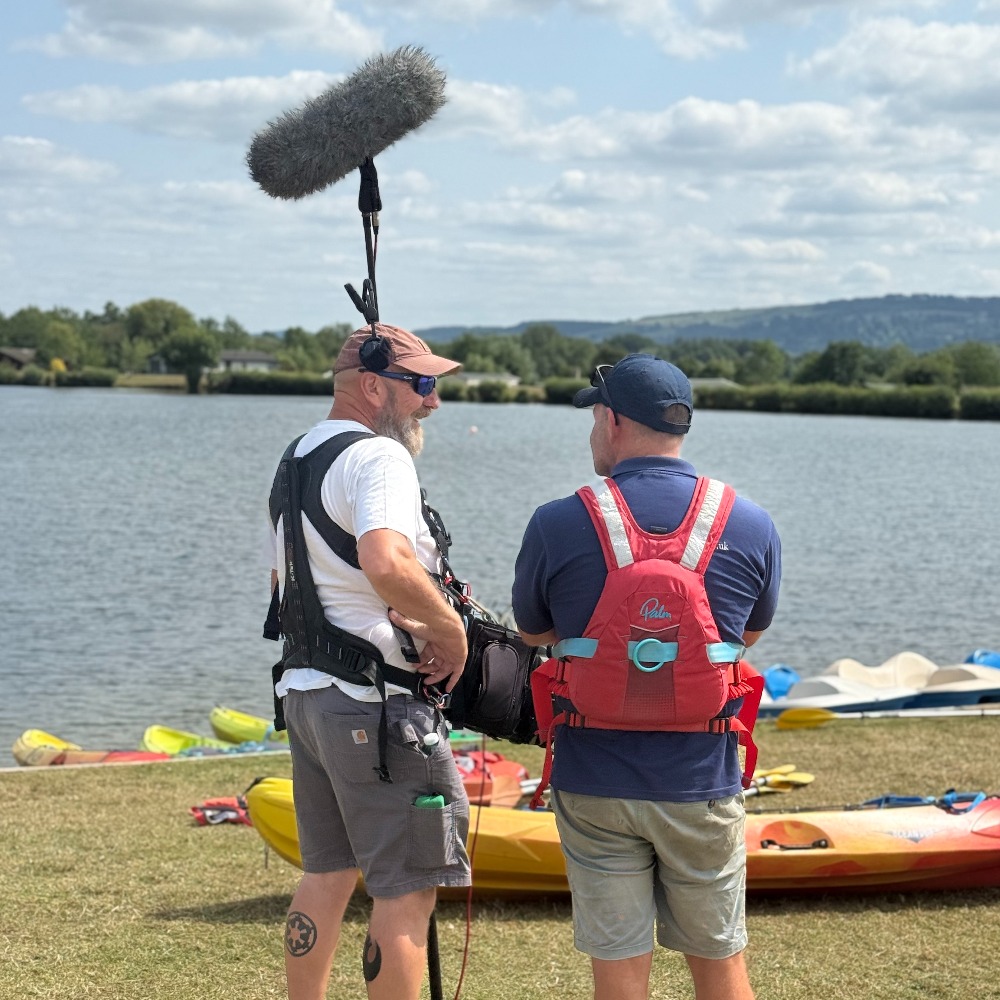 Four in a Bed sound crew filming kayaking activity by the lake at Aztec Adventure Lower Moor