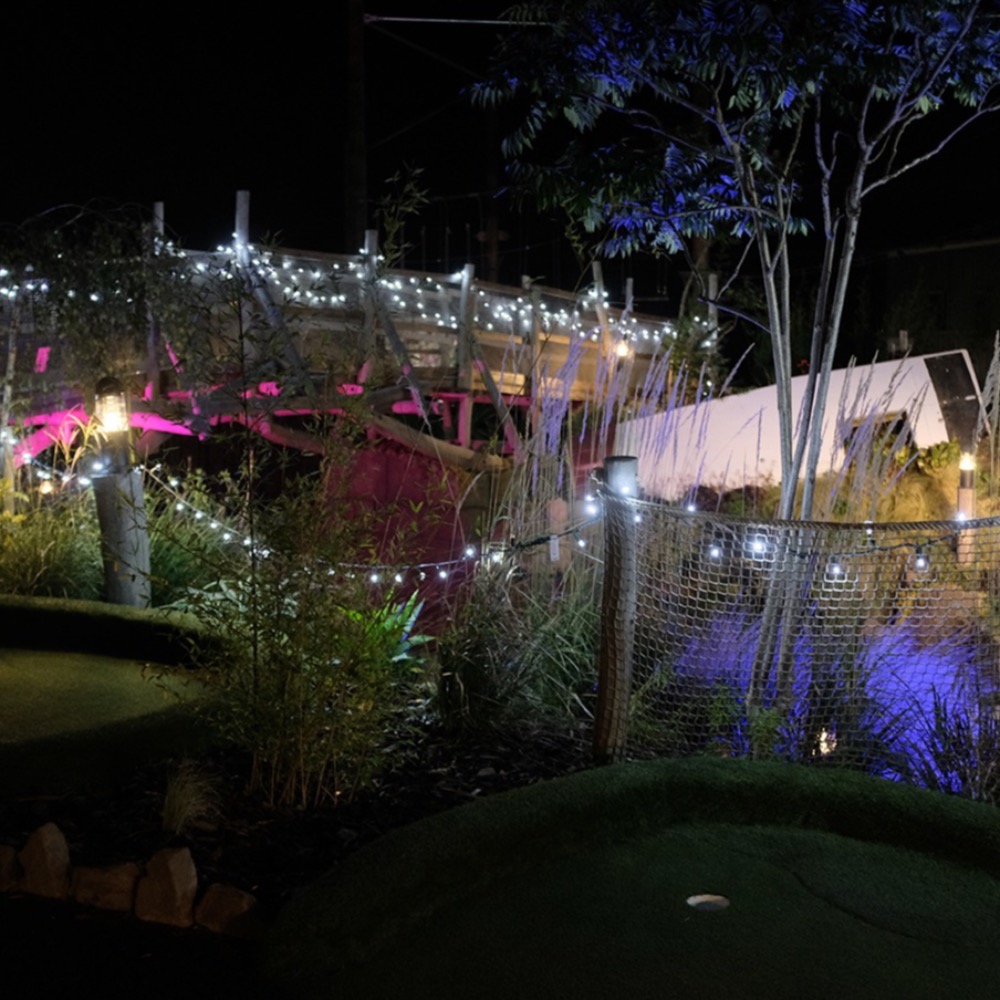 Glow-in-the-dark adventure golf course at Aztec Adventure Evesham decorated with Christmas lights and festive decorations