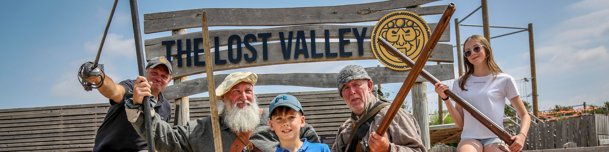Aztec Adventure's Mark Spence and reenactors mark the launch of Victory at The Lost Valley at The Lost Valley entrance sign