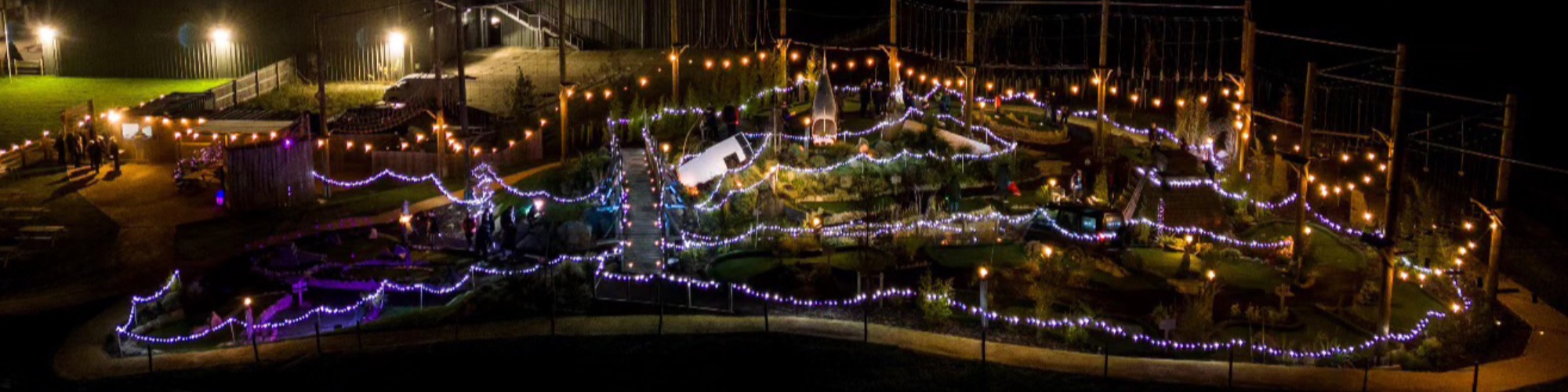 Glow-in-the-dark adventure golf course at Aztec Adventure Evesham decorated with Christmas lights and festive decorations