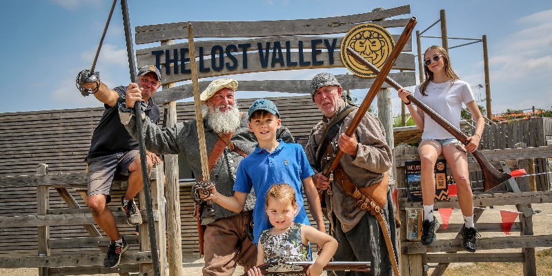 Aztec Adventure's Mark Spence and reenactors mark the launch of Victory at The Lost Valley at The Lost Valley entrance sign
