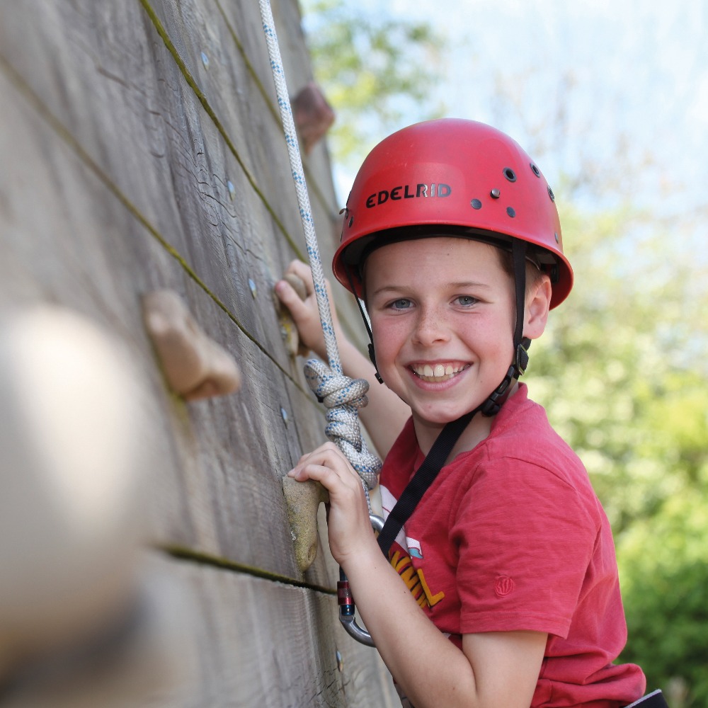 Boy on climbing wall at Aztec Adventure Upton Warren