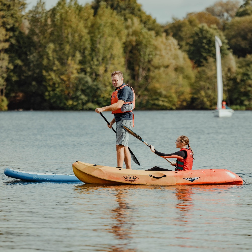 Family enjoying kayak and paddleboarding hire on open water at Aztec Adventure, Worcestershire