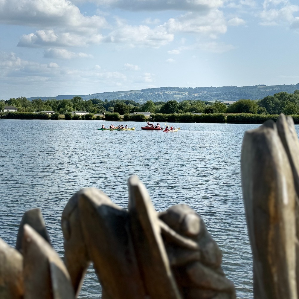 Contestants and film crew on the water during Four in a Bed filming at The Springs Holiday Park