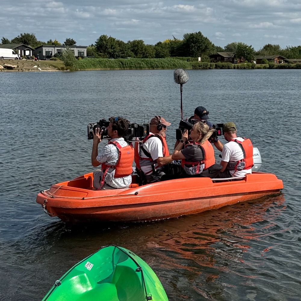 Channel 4 camera boat filming kayakers on the lake at Aztec Adventure Lower Moor