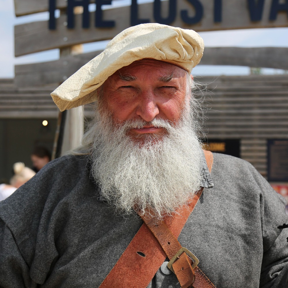 Costumed 17th-century reenactor at The Lost Valley entrance, part of the Victory at The Lost Valley Civil War themed adventure golf experience